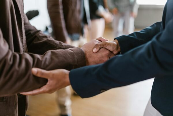 Close-up of two businesspeople shaking hands, symbolizing agreement and partnership.